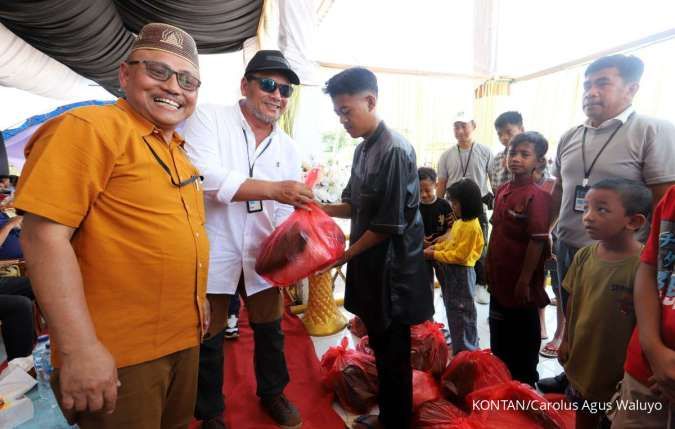 Direktur PT Biomasa Jaya Abadi (BJA) Iskandar bersama Direktur PT BJA Group Burhanuddin (kiri) menyerahkan bantuan kepada anak yatim piatu saat kegiatan Family Gathering di lapangan Popayato, Kabupaten Pohuwato, Gorontalo, Minggu (3/11).