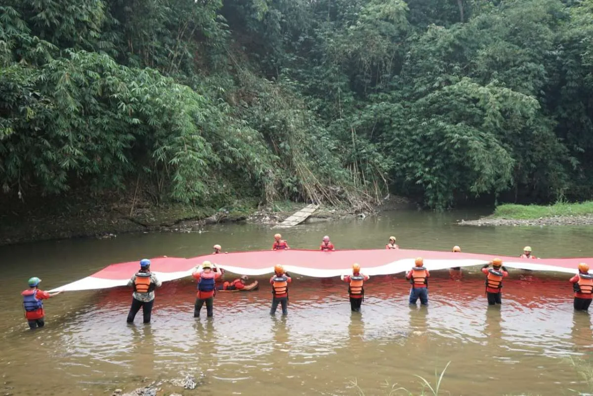 Askrindo bentangkan bendera merah putih sepanjang 74 meter di sungai Ciliwung