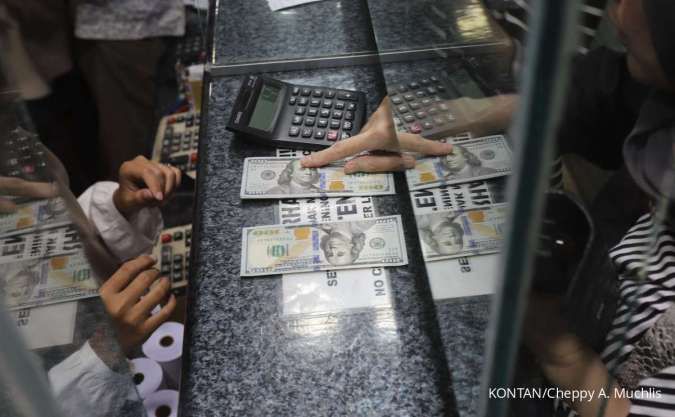 Petugas menunjukan uang asing Dollar Amerika Serikat (US$)